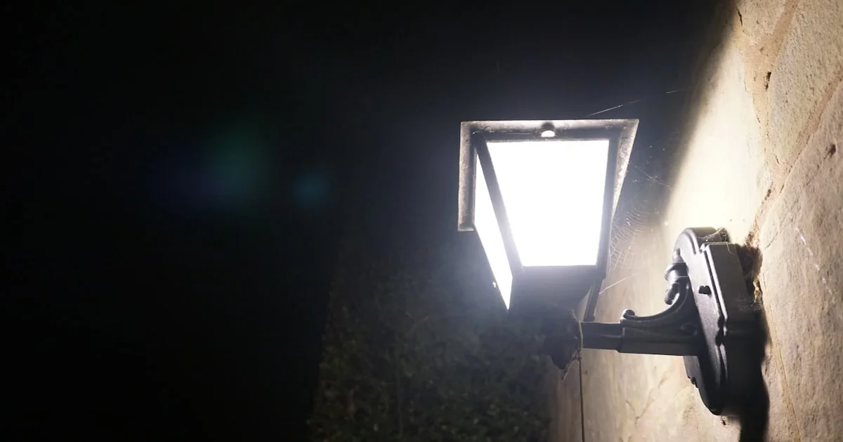 Bright outdoor security light illuminating a wall at night