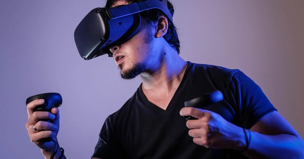 Person wearing a VR headset with motion controllers in a VR headset for beginners guide
