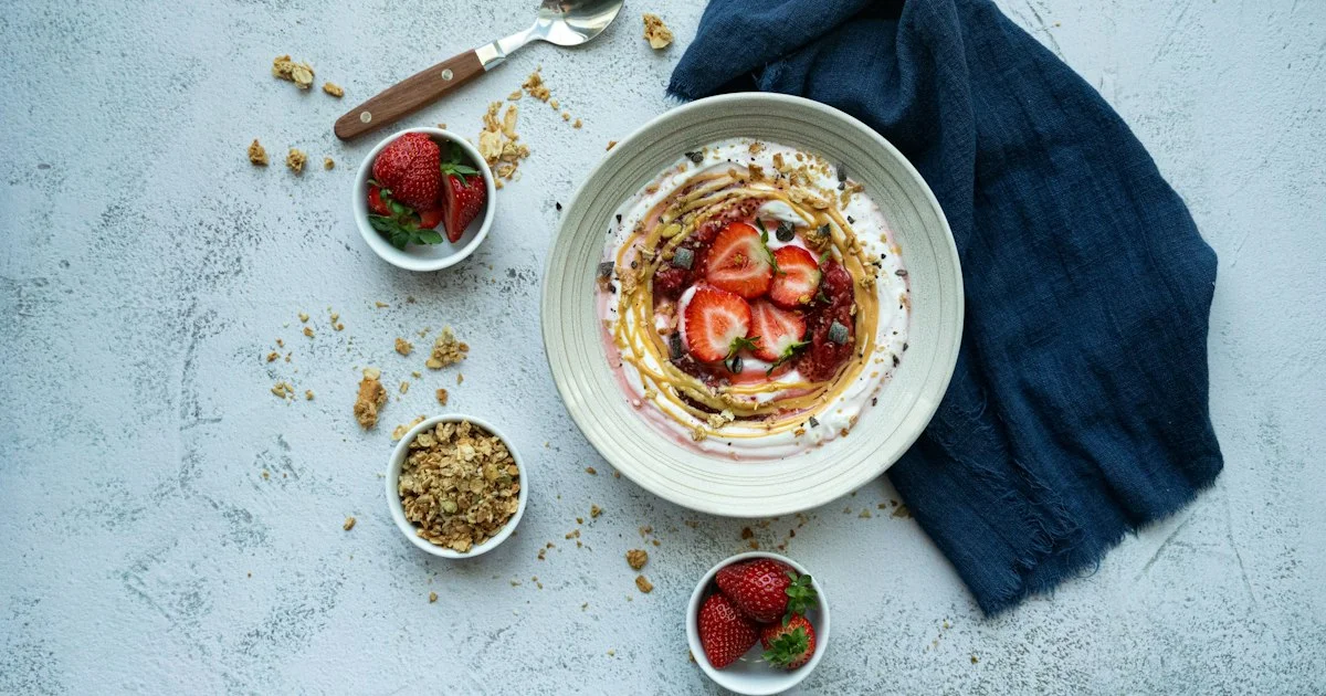A bowl of plain yogurt with granola and strawberries, the kind of item a best diabetic diet foods 2026 shortlist has to check on the label