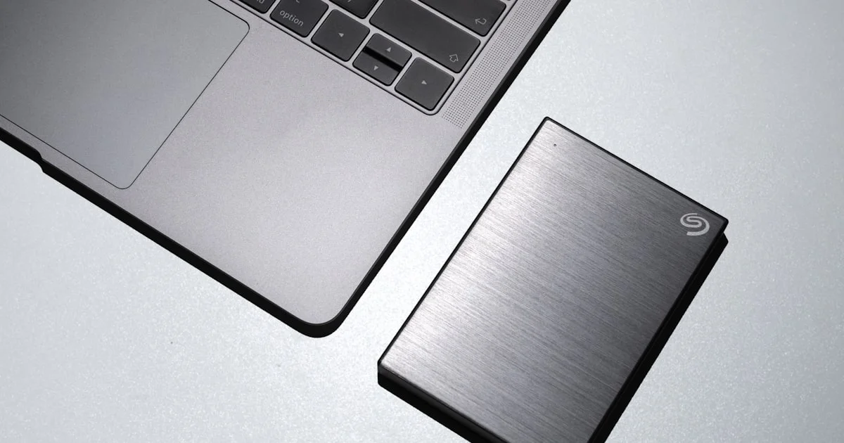 External SSD portable drive next to a laptop, used for gaming storage