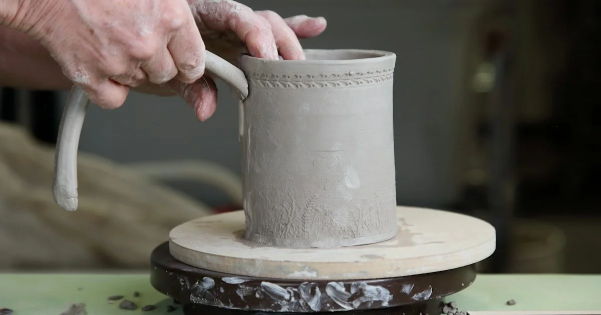 A potter attaching a handle to a clay mug by hand, the making step behind the Best Handmade Gifts Online 2026 listing categories