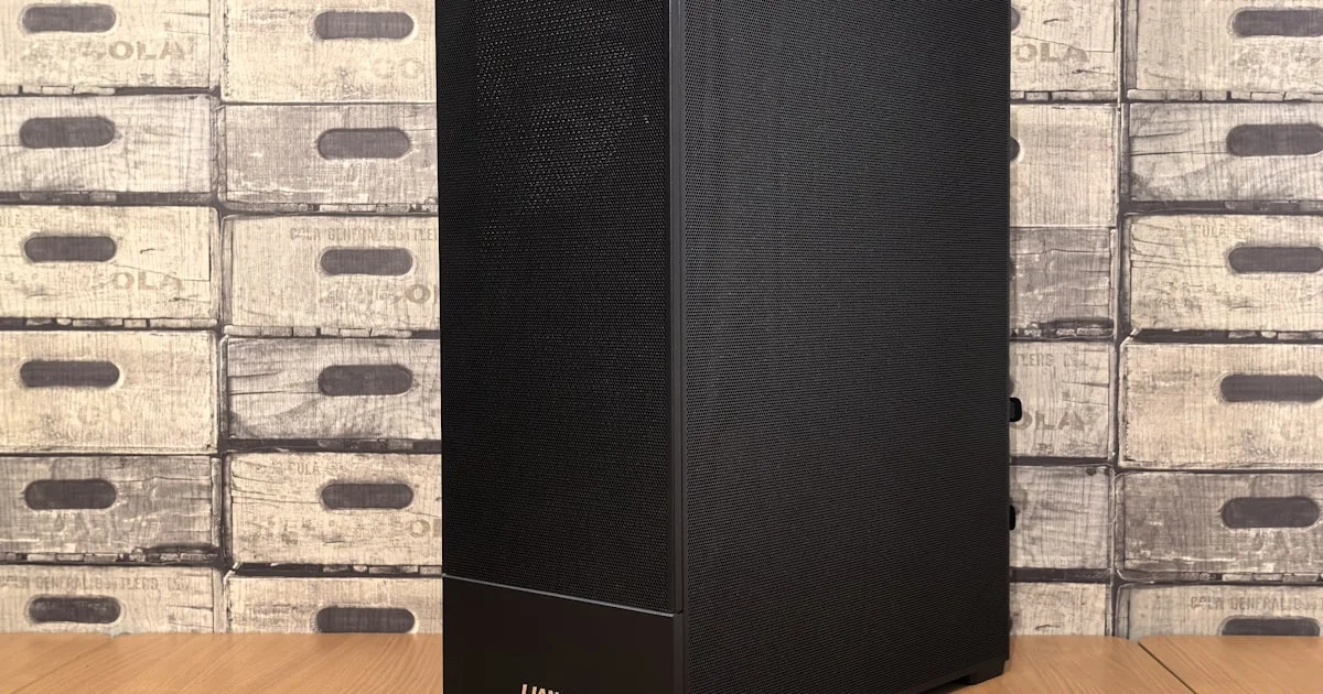 Compact black mini gaming PC tower case on a wooden desk