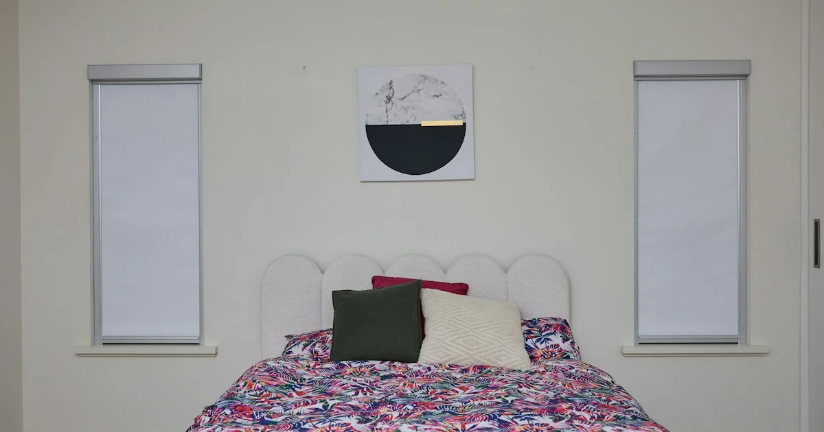 A bedroom with two cordless roller shades on the windows, the room a best smart blinds 2026 shortlist usually starts with