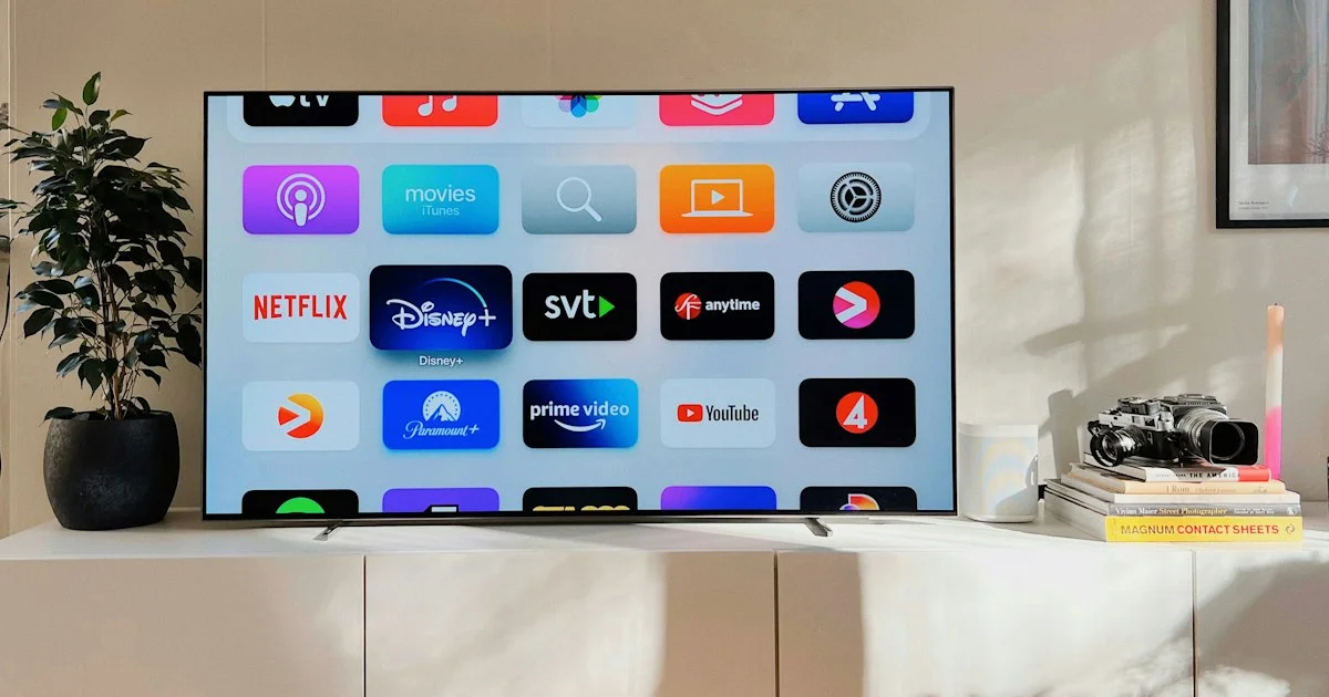 A smart TV on a living room console displaying a grid of streaming app icons