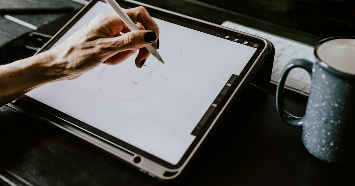 A person drawing on a tablet screen with a stylus at a desk
