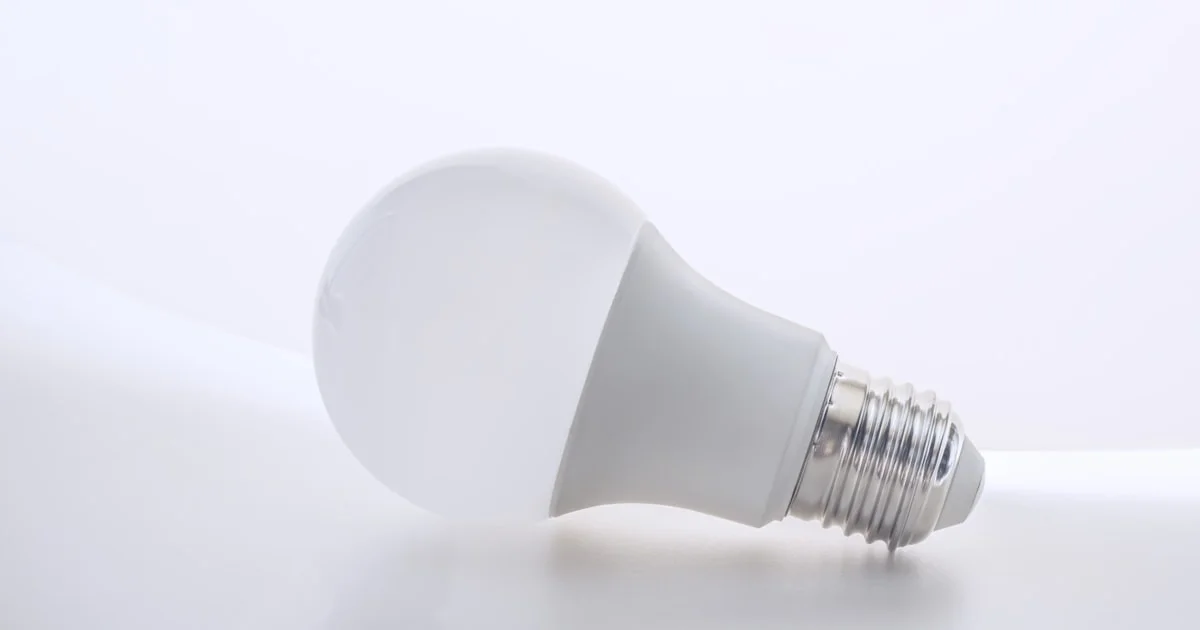 White smart LED light bulb on a plain background