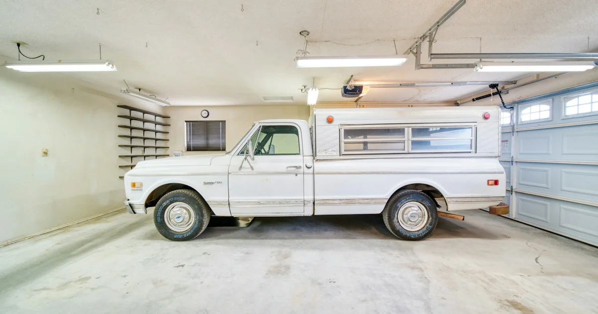 A home garage with the opener rail and motor unit mounted overhead, the hardware to assess when working out how to buy a smart garage door opener