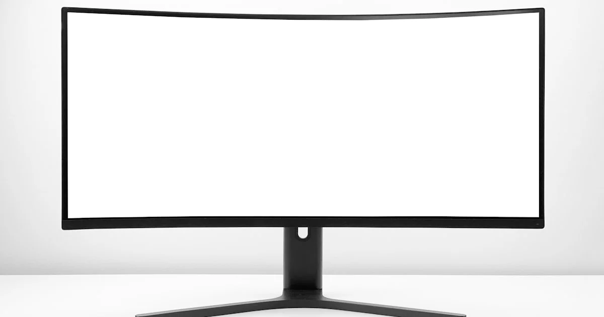 Curved white computer monitor on a clean desk representing a home office setup