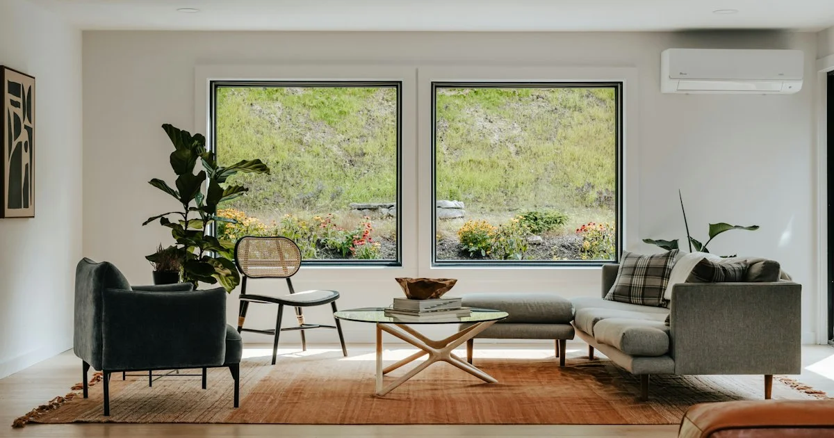 A bright living room with large windows, the room square footage that decides which top air purifier 2026 is the right size