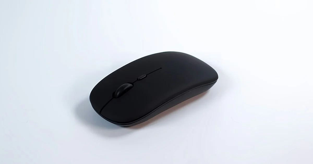 Slim black low-profile wireless mouse on a white surface, a travel-friendly shape to weigh when deciding which wireless mouse to buy in 2026