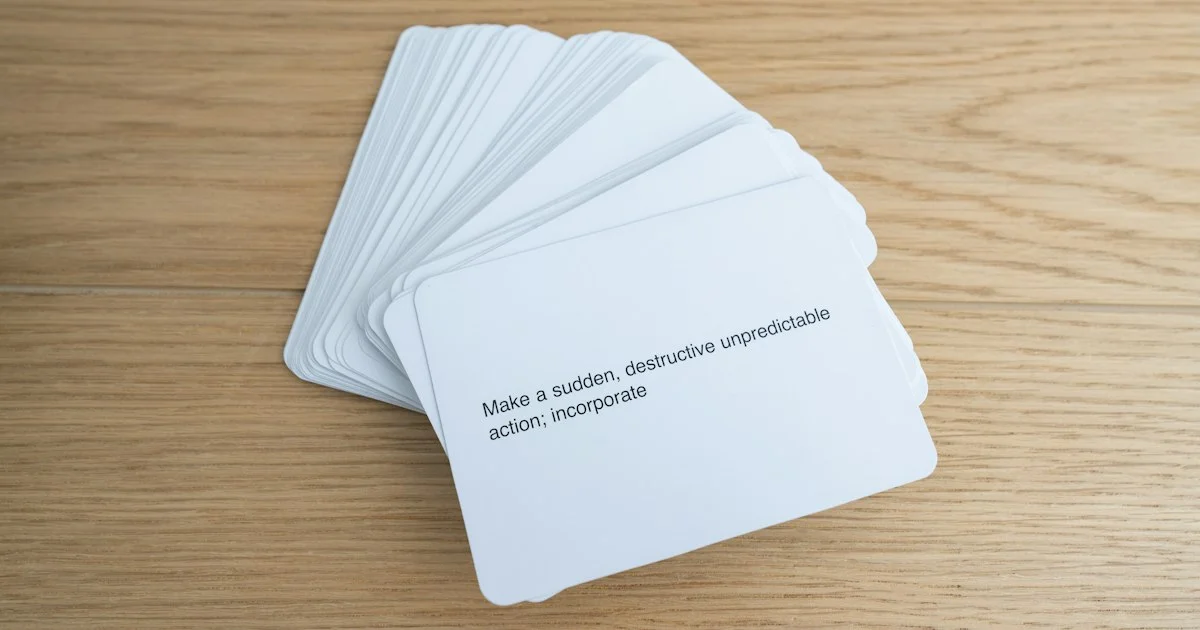 A fanned stack of plain paper vocabulary flashcards on a wooden table, the ordinary study tool behind any best language learning app 2026 decision