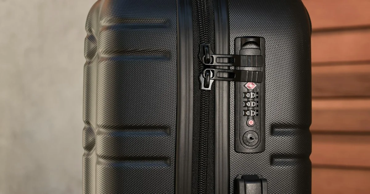 Integrated three-dial combination lock on a hardside suitcase, showing how to choose a bluetooth luggage lock against a built-in lock