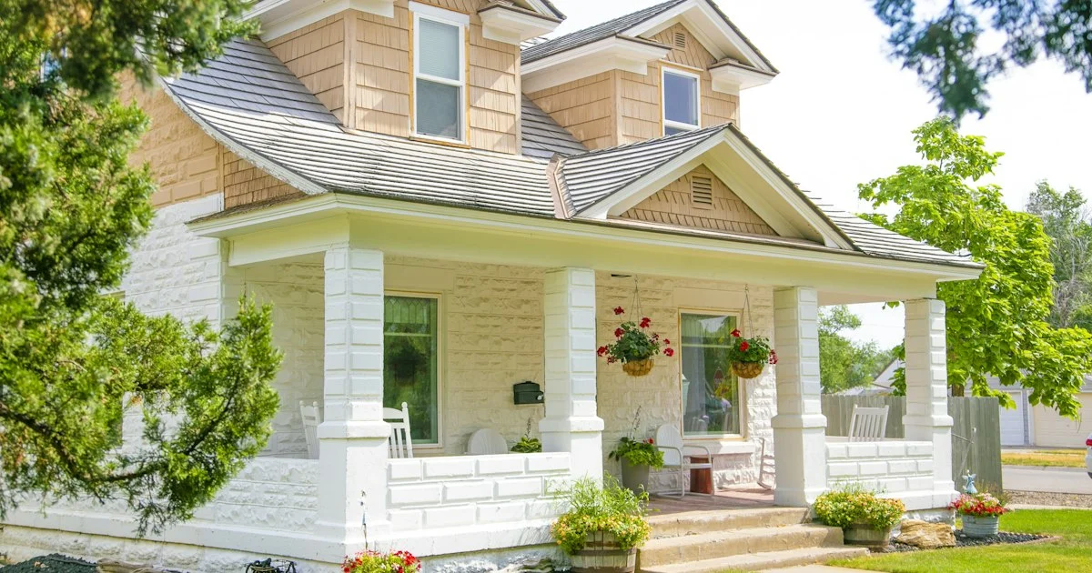 A white American house with a covered front porch and a wall mailbox, the address whose city rules decide which home security system should I buy